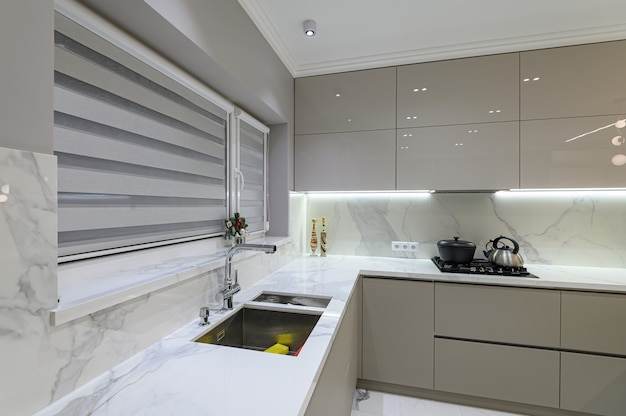 Luxury large modern white marble kitchen united with dining room