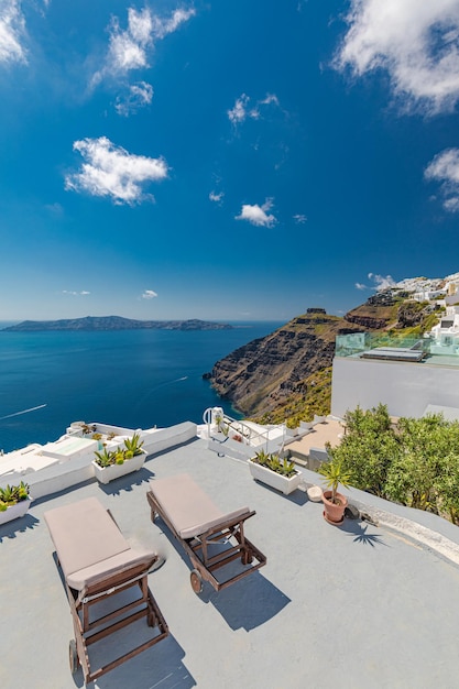 Luxury resort in Santorini. Loungers on caldera with pools and white architecture. Summer vacation