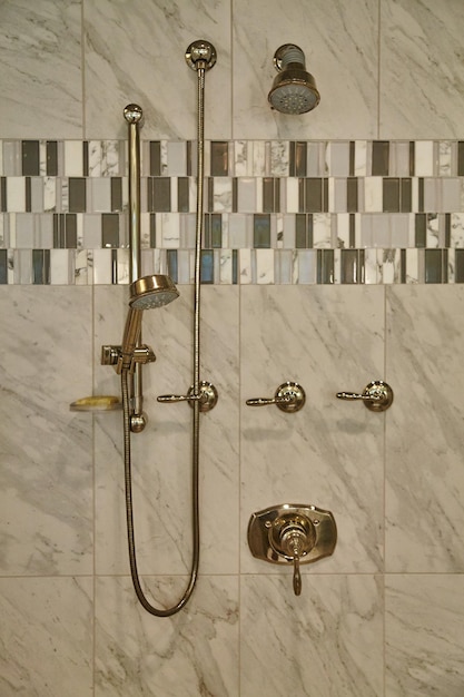 Luxury Shower System with Marble Walls and Mosaic Tile Detail