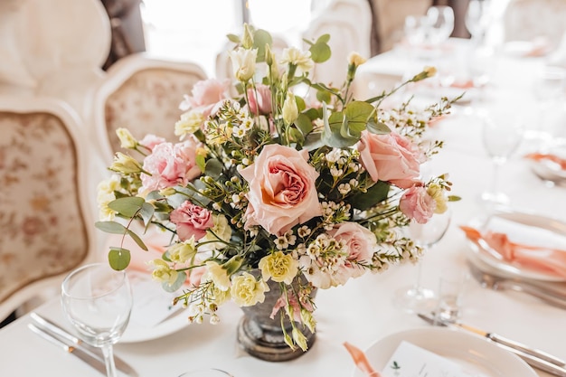 Luxury table setting for dining in a restaurant in pastel colors close up Wedding party table set for banquet