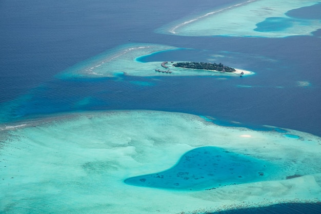 Luxury travel landscape Maldives aerial view tropical resort or hotel on paradise island reef atoll