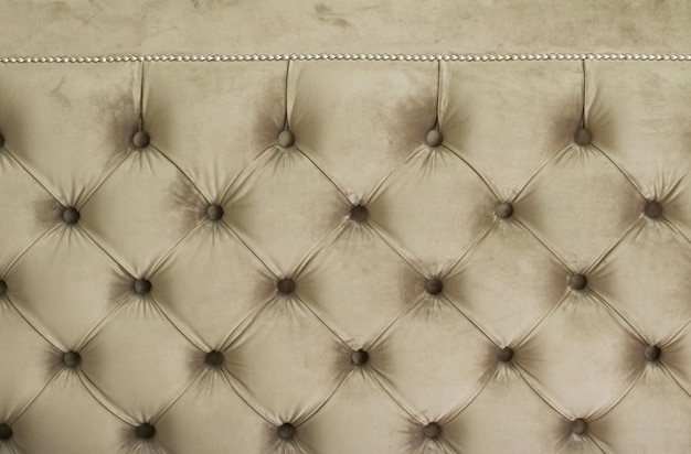 Luxury velour quilted sofa upholstery with buttons elegant home decor texture and background