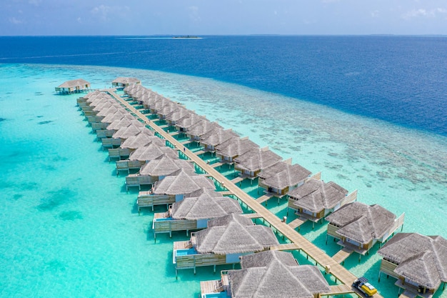 Luxury view of pool villas bungalows in Maldives resort Aerial paradise island tropical beach sea