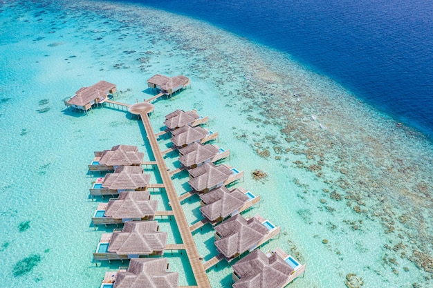 Luxury view of pool villas bungalows in Maldives resort Aerial paradise island tropical beach sea