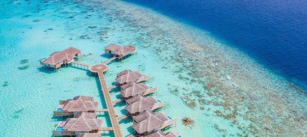 Luxury view of pool villas bungalows in Maldives resort Aerial paradise island tropical beach sea