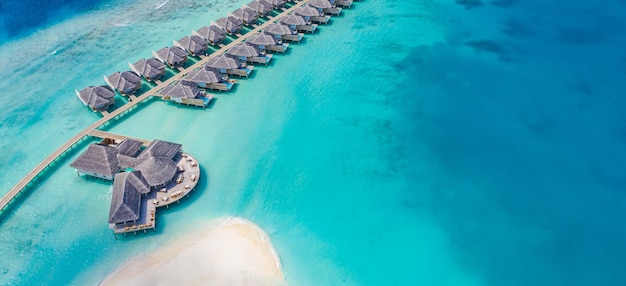 Luxury view of pool villas bungalows in Maldives resort Aerial paradise island tropical beach sea