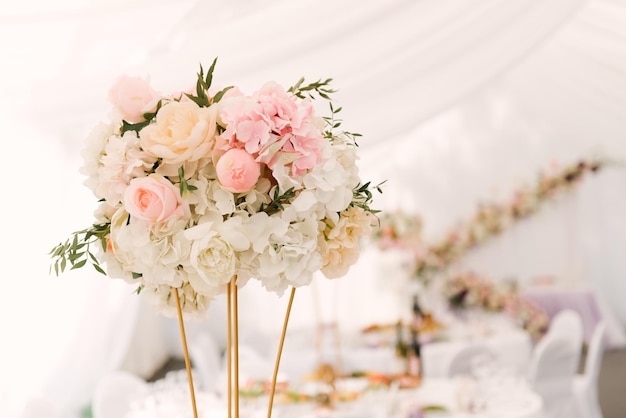 Luxury wedding dinner in a large beautiful tent beautiful decor for the wedding of the white hall decorated with flowers