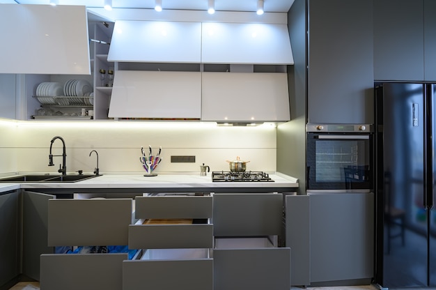 Luxury white and dark grey modern kitchen interior, front view