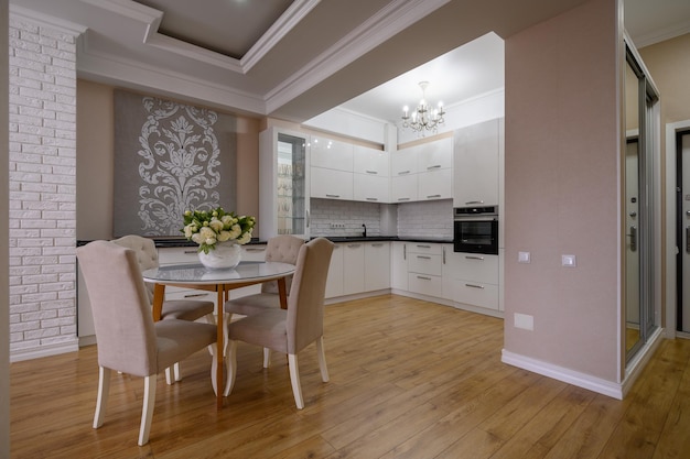 Luxury white modern kitchen with rose walls in studio apartment