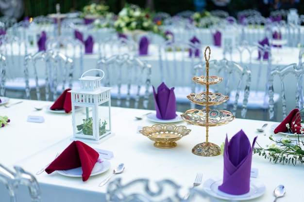 Luxury White - Purple - Red Dinner table set with Crystal chair in the garden.