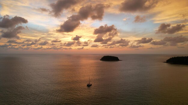 Luxury yacht at sunset with a view of the island