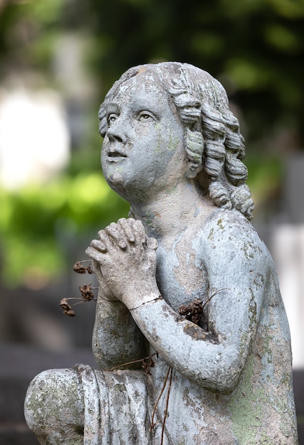 Lviv, Ukraine - May 25, 2020: Old Lychakiv Cemetery in Lviv. Old statue on grave in the Lychakivskyj cemetery