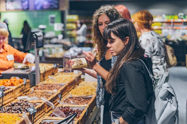 LVIV UKRAINE September 8 2018 people buying dried fruit in grocery store