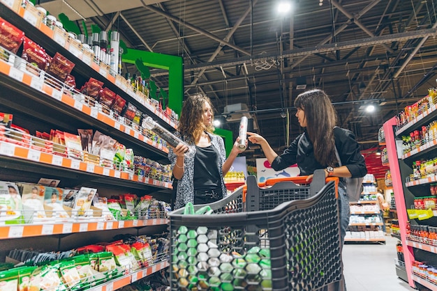 LVIV UKRAINE September 8 2018 two women choosing products in grocery store