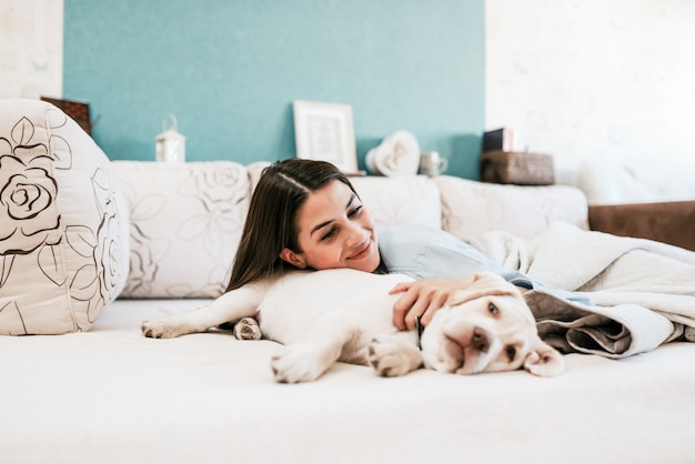 Lying in bed with a dog.