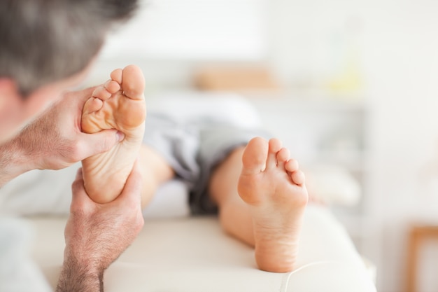 Lying Woman getting a reflexology massage