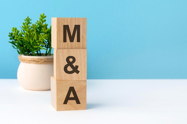 M and a word from wooden blocks with letters blue background copy space available