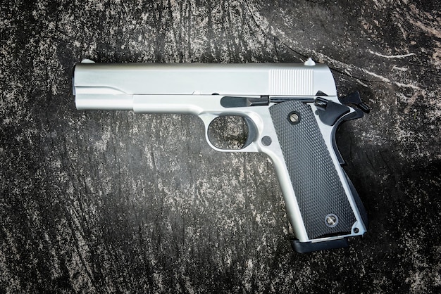 M1911 semi-automatic .45 caliber pistol on a grungy wood table