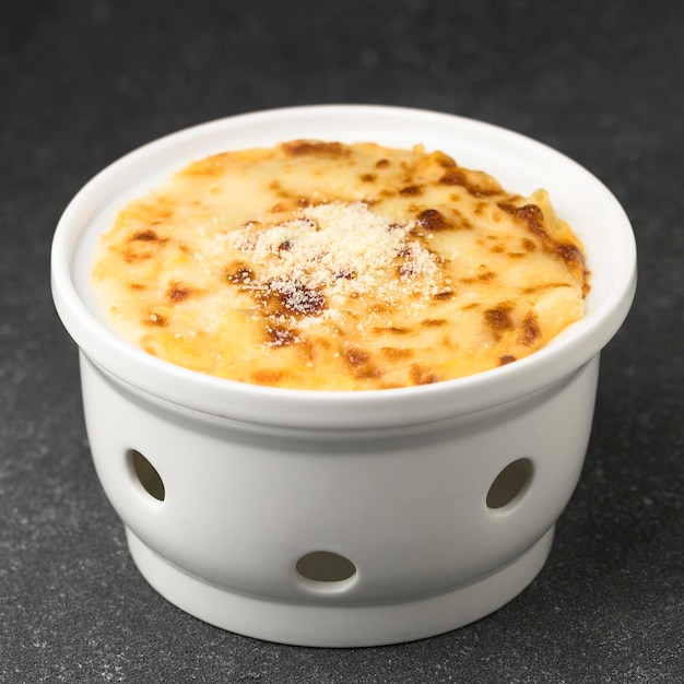 Mac and cheese baked pasta served in dish isolated on table top view of fastfood