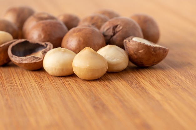 Macadamia nuts healthy nutrition food on wooden table