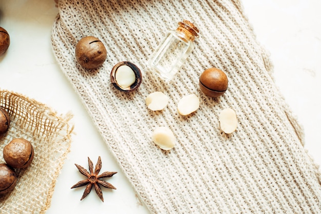 Macadamia nuts, natural butter, star anise and a warm sweater. Top view flat lay.