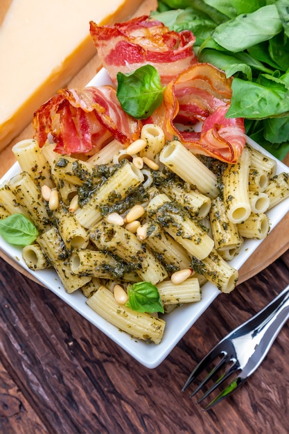 Macaroni with pesto penne rigate On a wooden table with a rustic look