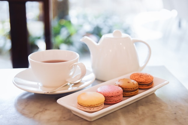 Macarons and tea cup served on the table