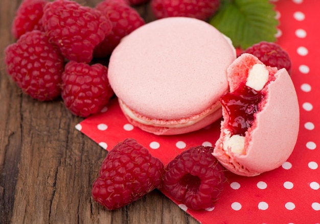 Macaroon with raspberries cookies on a wooden background