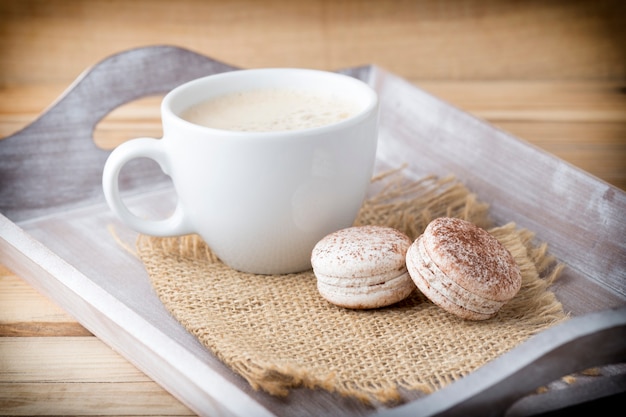 Macaroons and coffee on the table. 