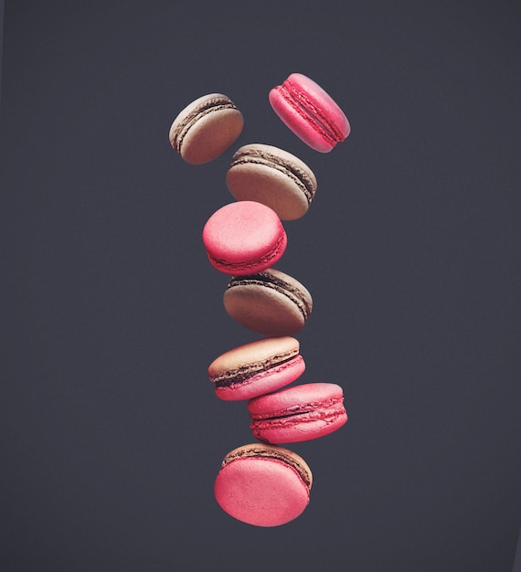 Macaroons on colored, composition of colorful french cookies macarons in the air