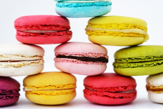 Macaroons in the form of a pyramid on a white surface. Horizontal orientation, close up.