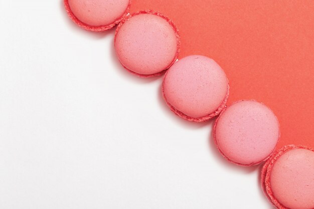 Macaroons on a pink and white background