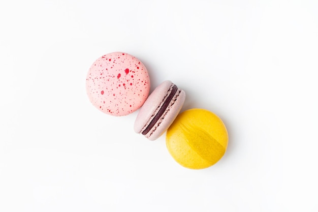 Macaroons sweet food on white background pastel yellow pink color background