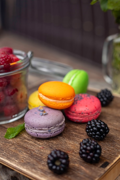 macaroons with berries on a wooden table