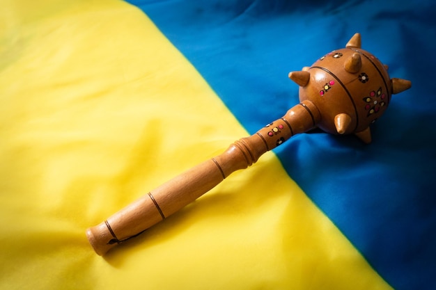 Mace weapon on ukrainian flag closeup