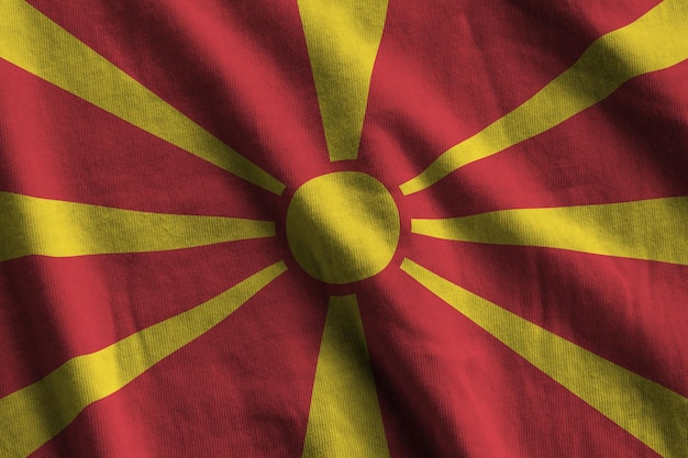 Macedonia flag with big folds waving close up under the studio light indoors The official symbols and colors in banner