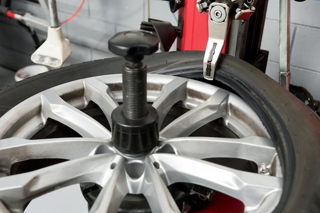 Machine dismantling tire in workshop