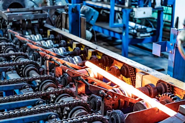 Machine for induction heating of metal A metal rod heated in an induction furnace Hot metal processing Metalworking in the industrial workshop at the factory