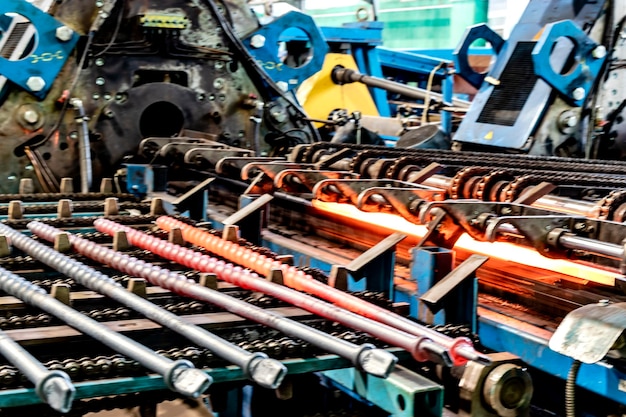 Machine for induction heating of metal A metal rod heated in an induction furnace Hot metal processing Metalworking in the industrial workshop at the factory