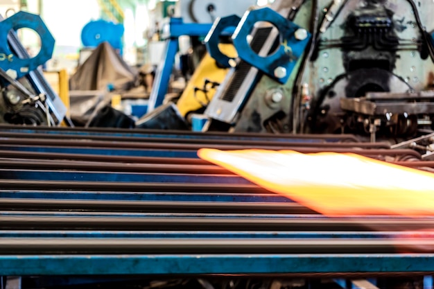 Machine for induction heating of metal A metal rod heated in an induction furnace Hot metal processing Metalworking in the industrial workshop at the factory