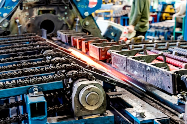 Machine for induction heating of metal A metal rod heated in an induction furnace Hot metal processing Metalworking in the industrial workshop at the factory