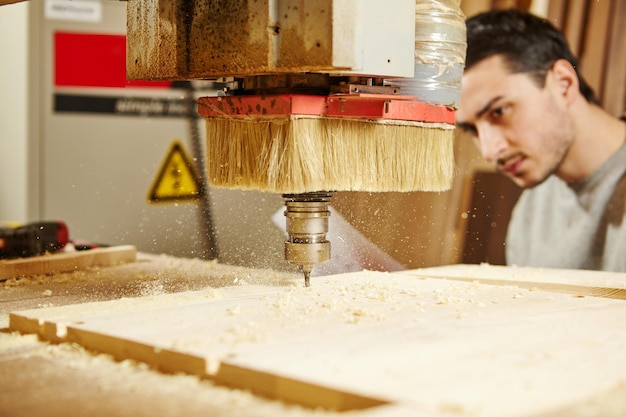 Machine with numerical control cuts wood CNC device in the carpentry shop