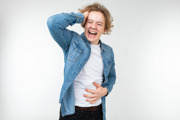 Macho guy in a plaid shirt wide open holding his hair on a white studio background.