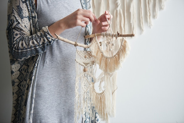 Photo macrame. women's hobby. the girl mistress during work