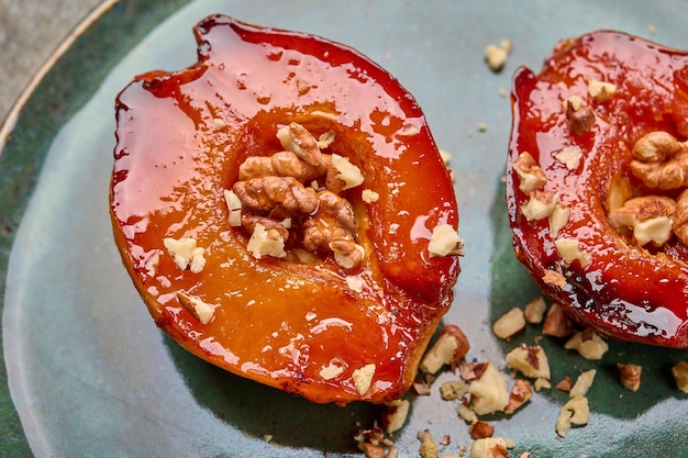 Macro baked quince with honey walnut and cinnamon on green plate selective focus