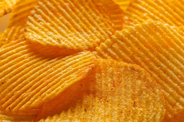 Macro of beautiful corrugated yellow chips under the sun's rays