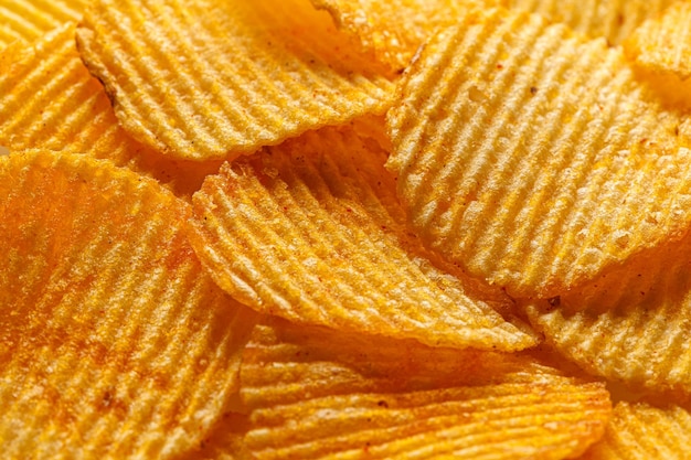 Macro of beautiful corrugated yellow chips under the sun's rays