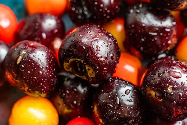 Macro close up of multicolored cherry berries with water drops on them