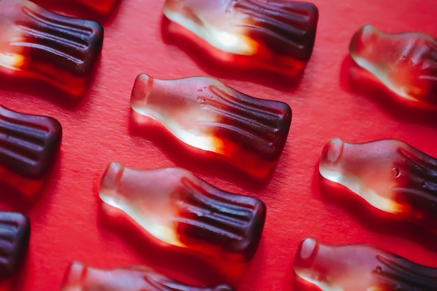 Macro cola gummy jelly candies pattern, bottle shaped sweets