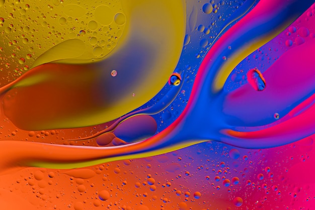 Macro drops of oil on the water surface with gradient effect. abstract background concept